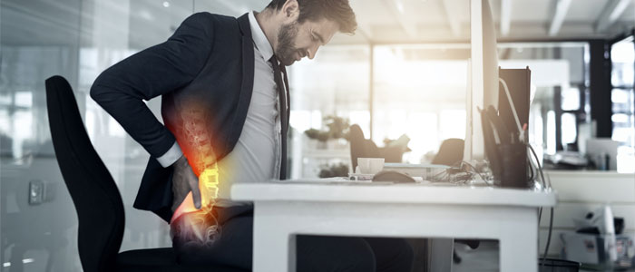 A man holding his lower back in pain