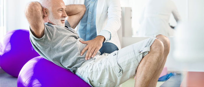 man doing crunches on physical therapy ball