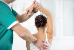 Woman receiving physical therapy on her shoulder.